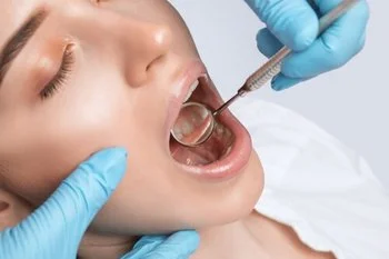 Close-up of a dental syringe and anaesthetic cartridge prepared on a clinical tray
